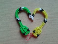 two braided bracelets in the shape of a heart on top of a table