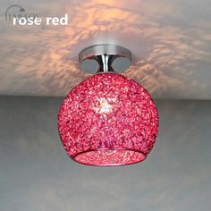 a pink light fixture hanging from the ceiling