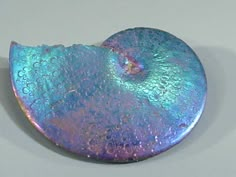 a piece of metal that is blue and purple