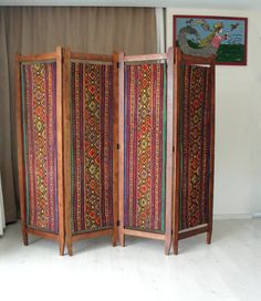 This gorgeous colorful bohemian upholstered wooden room divider would look great anywhere in your living room, office or bedroom. It is entirely made of solid cherry wood and is made in the 1920s or 1930s. PLEASE CONTACT US WITH YOUR LOCATION FOR AN EXACT SHIPPING QUOTE! It has been entirely sanded, stained and oiled. The original fabric was beyond redemption so we replaced it with vintage kilim. Making it a bold, rich, and statement piece of furniture. It would look great in the middle of a roo Room Divider Inspiration, 1920s Room, Privacy Screen Indoor, Wooden Divider, Privacy Screens Indoor, Hippie House, Screen Divider, Geometric Furniture, Large Bed