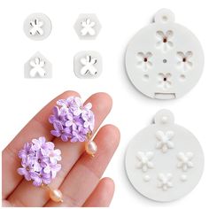 three pieces of white plastic with purple flowers and pearls on the top, one piece is being held by a person's hand