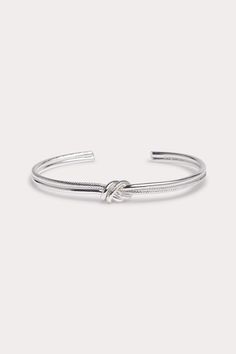 Our Austin Knot Bangle adds effortless cool to any look. Available in Silver. Shop Birdy Grey! This knotted bangle looks beautiful layered or worn alone. | Silver Jewelry | Birdy Grey Austin Knot Bangle Knot Bangle, Birdy Grey, Silver Shop, Birdy, Austin, Knot, Silver Jewelry, Bangles, Grey