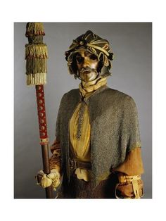 a statue of a man in costume holding a broom