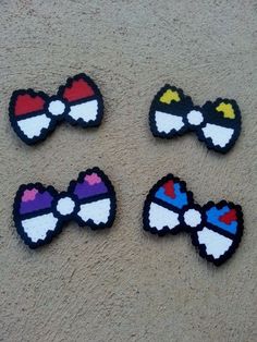 four pieces of colorful hair clips sitting on top of a carpeted floor next to each other