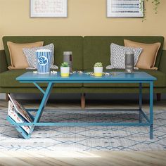 a green couch sitting next to a blue coffee table