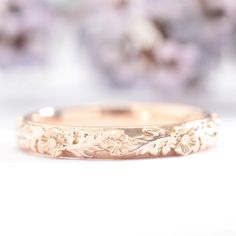 a close up view of a wedding band with flowers on it