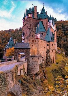 an old castle on the side of a hill