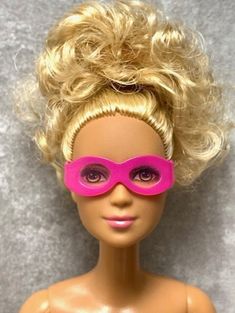 a doll with blonde hair and pink glasses