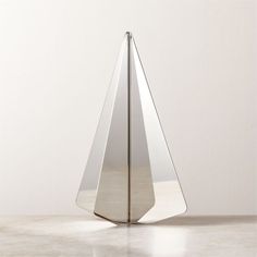 a metal object sitting on top of a white floor next to a wall and window