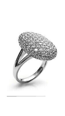 a white gold ring with pave set diamonds on the top, and an oval shaped band