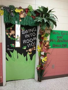 a classroom door decorated with paper flowers and jungle decorations for the front entrance to spring into reading room