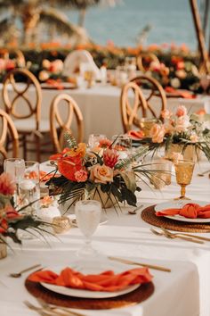 the table is set with orange napkins and place settings