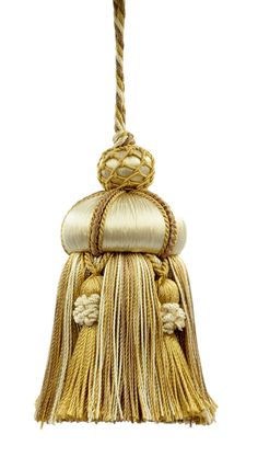 a gold and white tasselle hanging from a rope