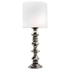 a silver lamp with a white shade on it