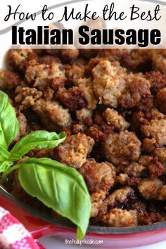 homemade italian sausage with basil leaves in a skillet on a red and white plate