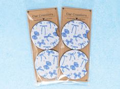 two blue and white coasters with bows on them