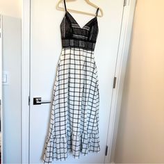 a white and black dress hanging on a door