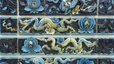 blue and yellow tiles with dragon designs on them