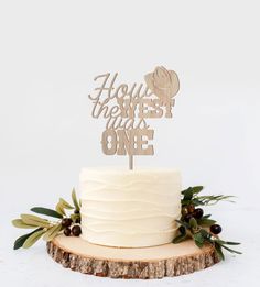 a white cake topped with a wooden sign