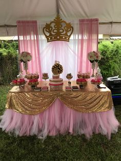 a pink and gold dessert table at a princess birthday party