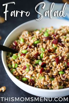 a white bowl filled with farro salad on top of a table