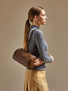 Editor's NotesThis bag from moiqui adds a casual mood to your outlook.- Trapezoid cylindrical silhouette- Thick and soft piping on both sides- Comfortable to wear with the layered shoulder strap- Zipper pocket on the backMeasurements(in.)- Size: 10.24 in. * 5.91 in. * 5.91 in.- Handle Drop: 12.20 in.Composition & Care- Vegan Leather- Avoid direct heat and moisture- In case of contamination, partial washing with neutral detergentDesigner- by moiqui Brown Satchel With Rolled Handles, Brown Satchel Bucket Bag With Rolled Handles, Brown Shoulder Bag With Rolled Handles For Work, Brown Bucket Shoulder Bag With Rolled Handles, Brown Workwear Bags With Rolled Handles, Piping, Zipper Pocket, Vegan Leather, Shoulder Strap