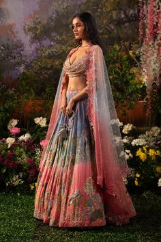 A captivating blend of hues and textures along with nalki crystals and lavish hand embroidery crafts this mesmerizing Iris lehenga set. The playful hues create that joyful vibe for the celebrations and as paired up with a glamorous cowl neck blouse the ensemble exudes a playful glam. With the complimentary net dupatta prepare to dazzle and make an unforgettable statement. The blouse features a cowl neckline embellished with sequins, beads, and nalki crystals. The blouse comes with attached rhine Luxury Festival Lehenga With Zari Work, Luxury Multicolor Embroidered Gown For Festivals, Luxury Spring Embellished Lehenga, Luxury Lehenga With Zari Work For Festivals, Luxury Festival Lehenga With Unstitched Blouse, Luxury Embellished Lehenga For Spring, Luxury Multicolor Gown With Cutdana, Luxury Lavender Designer Lehenga, Luxury Semi-stitched Lehenga For Festival