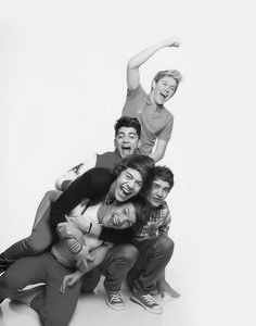 a group of young people posing for a photo in front of a white background,