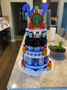 a cake made to look like a tower with beer bottles on it