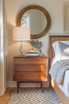 a bedroom with a bed, nightstand and mirror