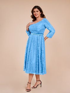 a woman in a blue dress posing for the camera