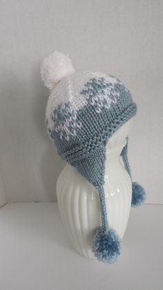 "This is a baby's hand knitted hat in a snow flake pattern done in blue and white using a super soft yarn.  The hat has a pompom on top and at the end of the ear flap ties.   The hat is for a baby of 6 months.  Measurements are 14\" circumference, unstretched and is 5.25 inches tall. Care:  Machine wash and dry on delicate settings." Snow Flake Pattern, Baby In Snow, Flap Hat, Ear Flap Hats, Snow Flake, Hand Knit Hat, Baby Hands, Knitted Hat, Soft Yarn