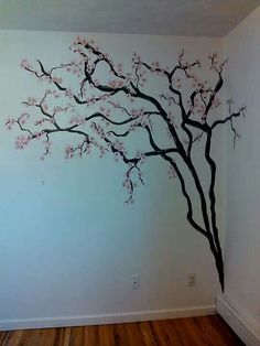 a tree with pink flowers painted on the wall