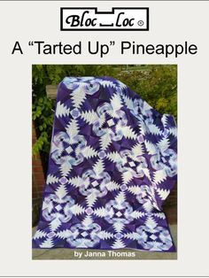 a purple quilt with white flowers on it and the words, a tarted up pineapple