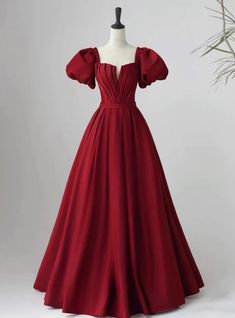 Garnet elegance in dress form �?isn't this what fairy tales are made of? Imagine stepping into the ballroom, the rich, red hue of this prom dress making a bold statement, as timeless as it is modern. This exquisite gown is designed for those who seek a blend of classic charm and contemporary flair. Its off-the-shoulder puff sleeves add a touch of regal sophistication, while the fitted bodice beautifully transitions into a soft gathering at the waist, accentuating the silhouette. The full A-line skirt, crafted from flowing fabric, cascades to the ground, creating an air of majestic grace with each step. Perfect for prom, this dress promises to be a cherished ensemble that speaks volumes of your impeccable taste and confidence. Occasion Dresses Wedding Guest, Burgundy Prom Dress, Custom Size Dresses, Dress A Line, Satin Prom Dress, Prom Dresses Blue, Evening Party Dress, Party Dress Long, Long Prom Dress