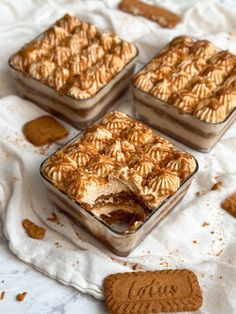 three desserts sitting on top of a white cloth