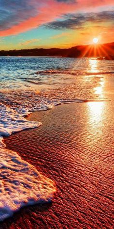 sunset on the beach with waves and clouds