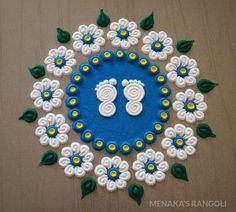 a blue and white circular design with flowers on the side, surrounded by green leaves