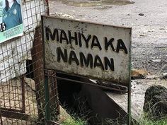 an old sign that says mahiya ka naman in front of a fence