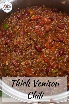 a bowl filled with chili and beans on top of a table