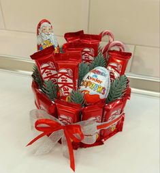 a basket filled with candy and candies on top of a white counter next to a wall