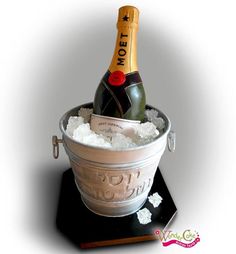 a bottle of champagne sitting in a bucket filled with ice and snow on top of a table