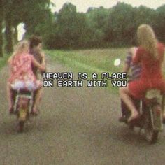 three people riding bikes with the words heaven is a place on earth with you