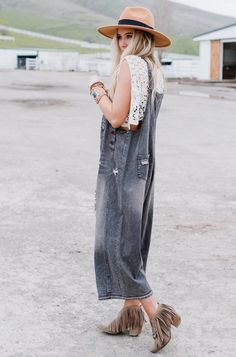 This oversized silhouette is the perfect slouchy relaxed fit. It's washed denim is a loose fit with adjustable button straps and some distressed detailing. Oversized relaxed fit – if you are between sizes, please size down. Model is 5' 8" and wearing a size small. Approximate measurements are as follows: SMALL: Bust: 40" (measured from under arm), Waist: 50, Length: 35" (from under the arm to hem), Inseam: 21" MEDIUM: Bust: 42" (measured from under arm), Waist: 52, Length: 35 1/4" (from under th Summer Distressed Washed Black Jeans, Oversized Washed Black Denim Jeans, Oversized Washed Black Jeans For Spring, Stonewashed Relaxed Fit Jeans For Spring, Trendy Distressed Overall Bottoms, Oversized Distressed Jeans For Summer, Dark Wash Distressed Overalls, Trendy Distressed Jeans Overalls, Trendy Distressed Overall Jeans