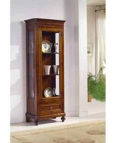 a tall wooden cabinet with glass doors in a living room