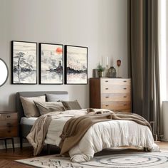 a bed room with a neatly made bed and two paintings on the wall