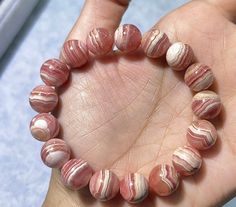 Material:Rhodochrosite beads size :  11mm   color:pink quantity: one strand  6mm approx 29 pcs one strands 7mm approx25 pcs one strands 8mm approx 22 pcs one strands 9mm approx 21pcs one strands 10mm approx 19 pcs one strands 11mm approx 18pcs one strands 12mm approx 16 pcs one strands 13mm approx 16 pcs one strands 14mm approx 15 pcs one strands 15mm approx 14pcs one strands 16mm approx 14 pcs one strands 17mm approx 13pcs one strands 18mm approx 13pcs one strands 19mm approx 12pcs one strands 20mm approx 12pcs one strands PLEASE NOTE: 1.Due to lighting effects, monitor's brightness/contrast settings etc, there could be some slight differences in the color tone of the pictures and the actual item. 2.Each piece of natural crystal is unique, the imperfections add natural characters to them. Pink Agate Bracelets With 8mm Beads, Pink Agate Round Bead Crystal Bracelet, Pink Agate Beaded Bracelets, Pink Agate Spiritual Bracelets, Pink Agate Healing Bracelet, Pink Agate Hand-strung Bracelets, Pink Agate Jewelry With 8mm Beads, Pink Agate Crystal Bracelet As A Gift, Pink Opal Round Beads Bracelet