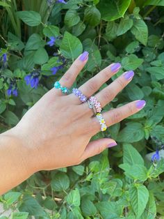 Beaded flower rings with green pastel petals. These are made with beads and elastic and a crimp bead to keep the elastic from being pulled apart.  Sizes:  You can choose from 3 sizes (1,2,or 3)  Size 1- fits ring sizes from 3-4  Size 2- fits ring sizes from 5-6  Size 3- fits ring sizes from 7-8 Or  Write your desired length in centimeters in the custom box. These rings will be sent with stamps without tracking info Please let me know if you have any questions! -Lorena Adjustable Beaded Rings For Summer, Adjustable Flower Ring For Summer, Adjustable Multicolor Spring Rings, Spring Multicolor Adjustable Rings, Adjustable Multicolor Flower Ring With Beads, Adjustable Multicolor Flower Ring With Colorful Beads, Adjustable Multicolor Beaded Flower Ring, White Beaded Flower Shaped Ring, Adjustable Flower Promise Ring For Spring