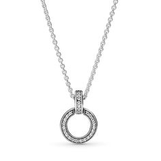 Make a statement with the Double Circle Pendant and Necklace. This sterling silver necklace features two circles merged to form a pendant. The top circle includes a row of clear cubic zirconia pavé along the edge and the Pandora logo on one side. The bottom circle swings back and forth from the top circle and features clear cubic zirconia pavé on one side and cut-out hearts on the other. Turn the necklace to switch up your look. Pandora Logo, Cz Pendant, Circle Pendant, Pandora Jewelry, Sterling Silver Necklace, Sterling Silver Necklaces, Circles, Cubic Zirconia, Silver Necklace