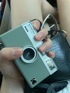 a person holding a camera in their hand